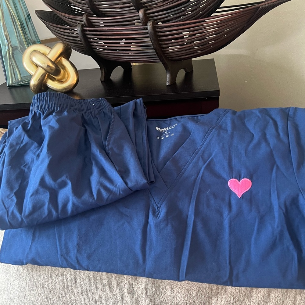 Unisex medical scrubs. Blue with pink embroidered 🩷on left upper side of shirt.